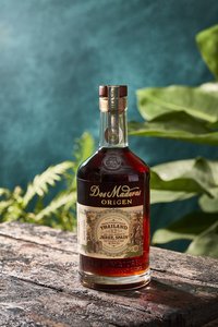 Dos Maderas Origen Thailand on table and plant in the background.jpg